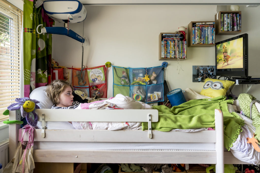 Child in bed watching tv