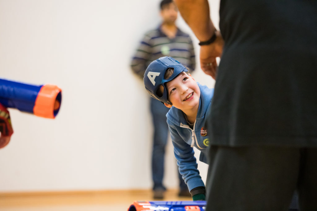 HemiHelp event - smiling child wearing hat with letter A on it