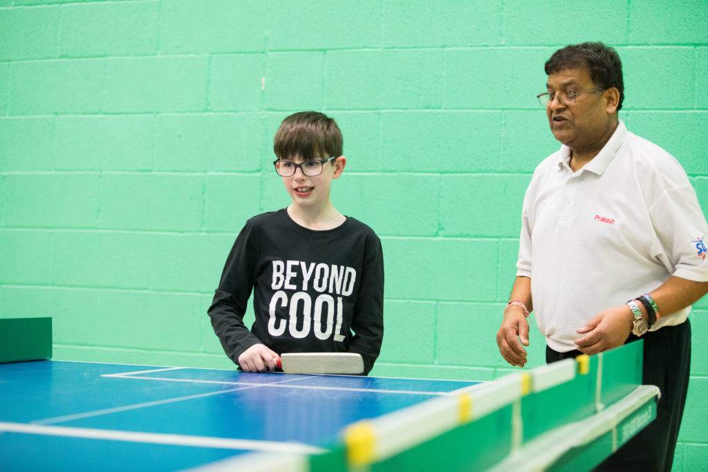 HemiHelp event - teenager with adult playing table cricket