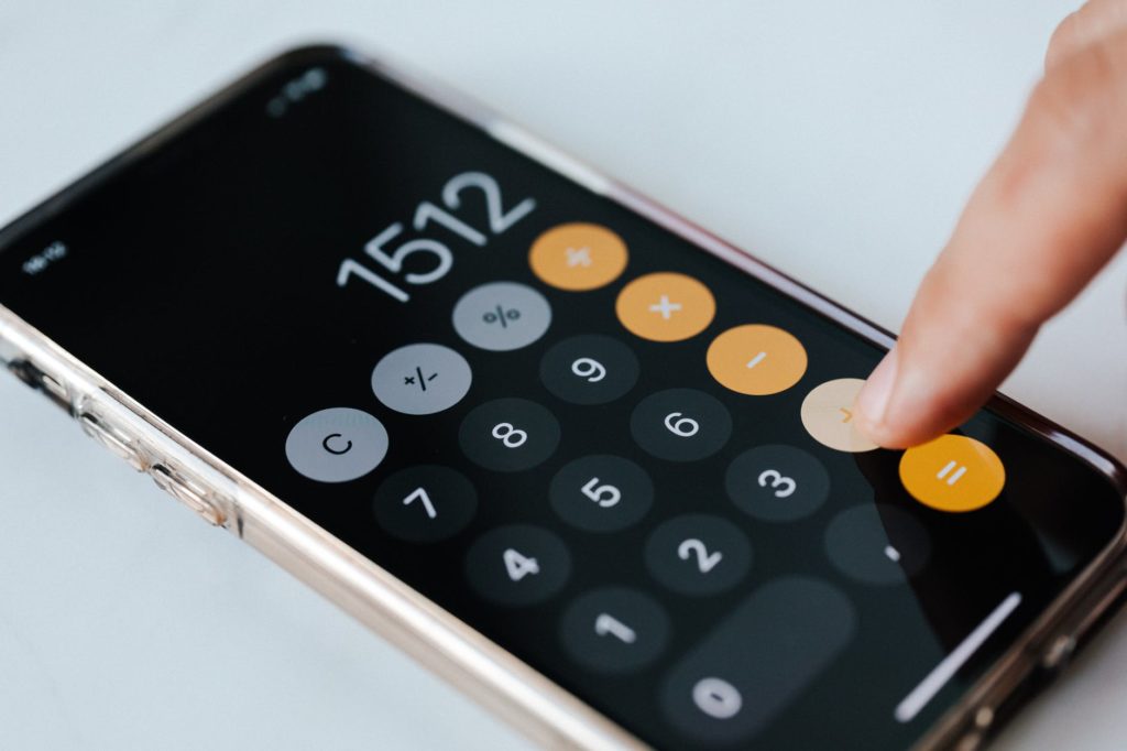 Someone doing sums on an iphone calculator