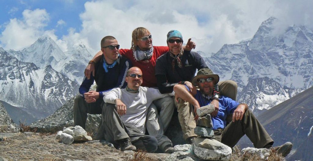 5 men smiling on top of Mount Everest