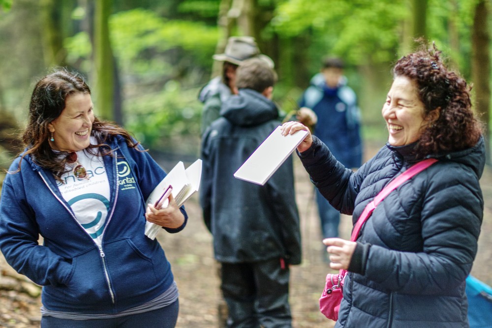 Contact staff member with parent at forest school event