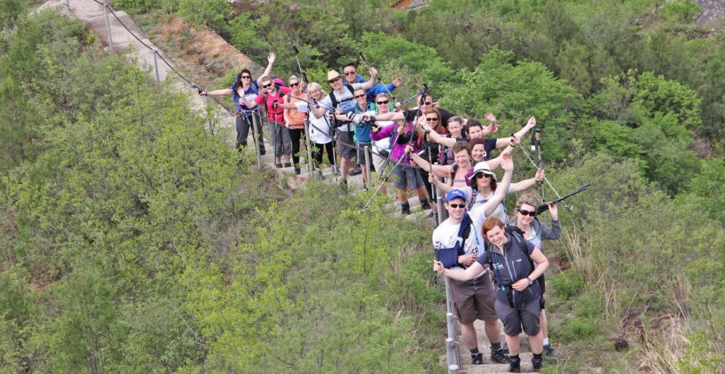 Group of people trekking across the Great Wall of China