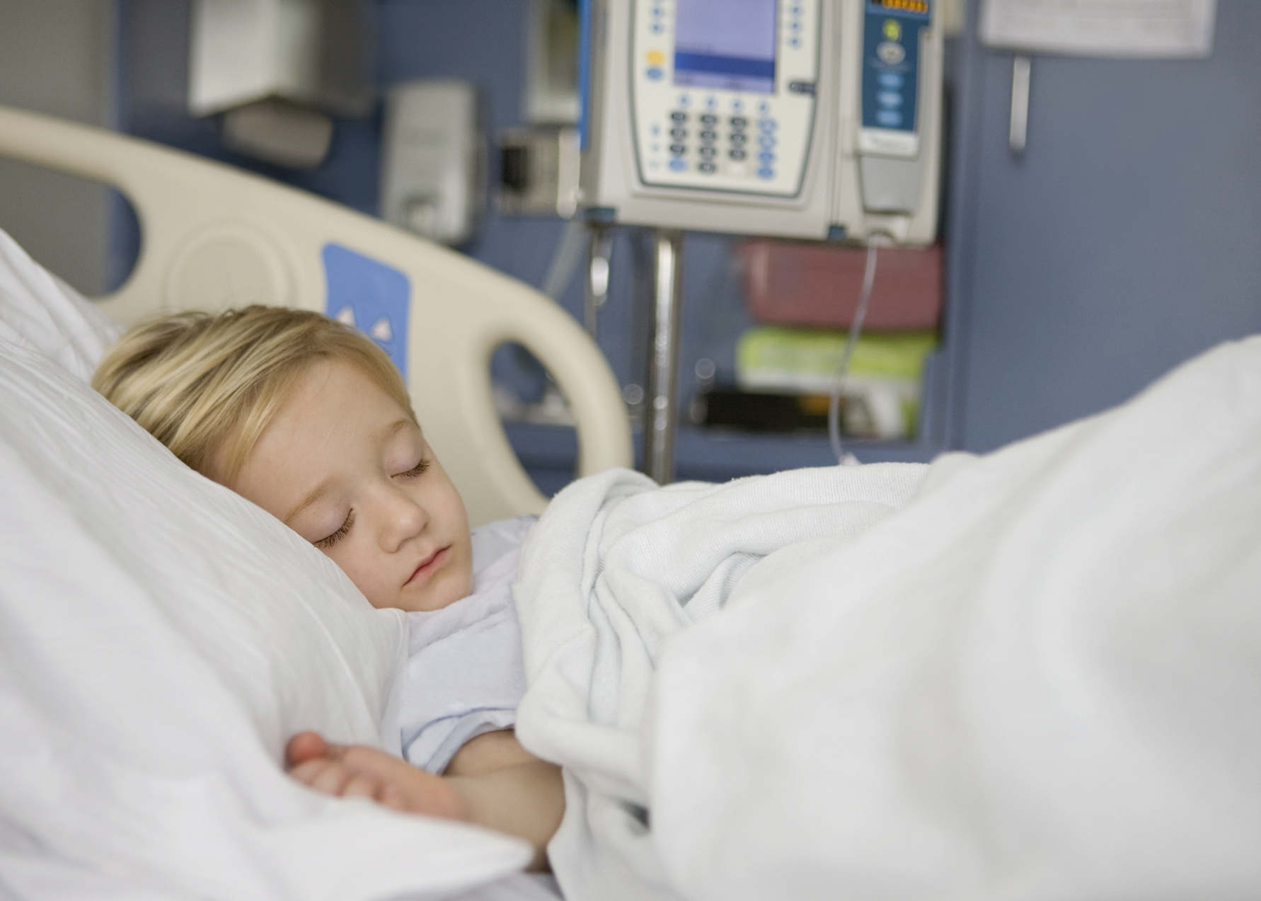 Young girl sleeping in hospital bed