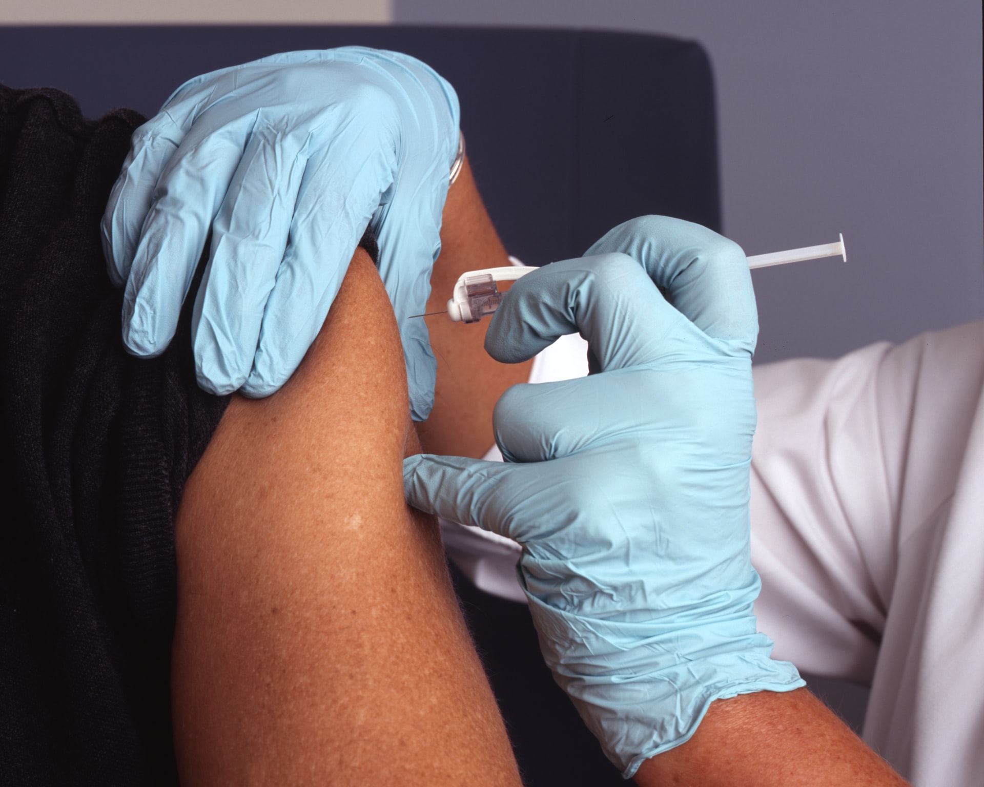 Arm receiving vaccination injection