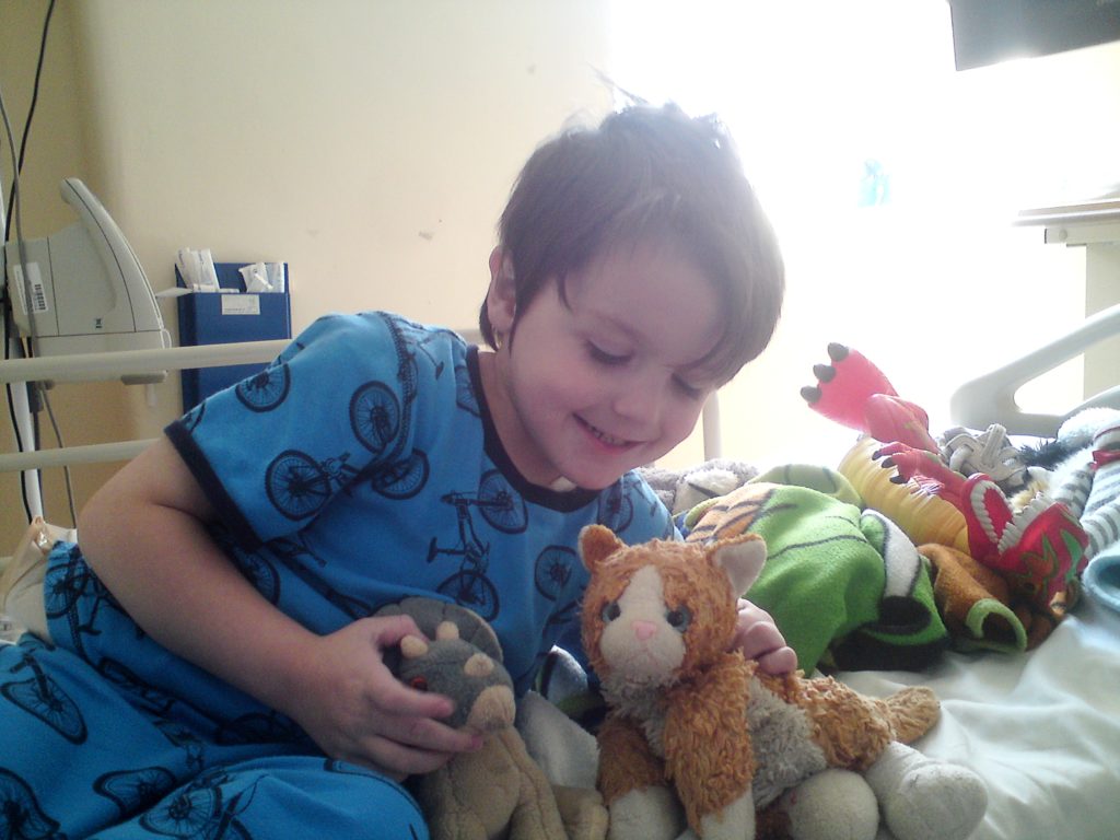 Child with dinosaur toy