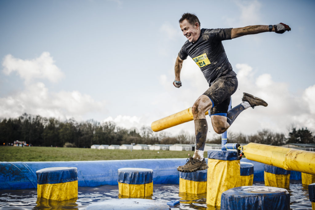 Man running through an obstacle course