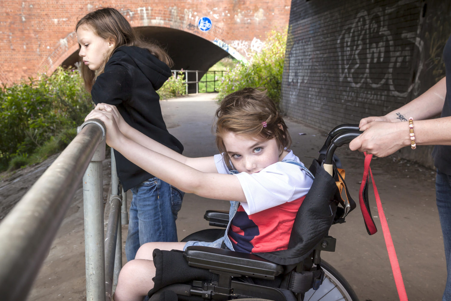 Young girl in wheelchair by the canal