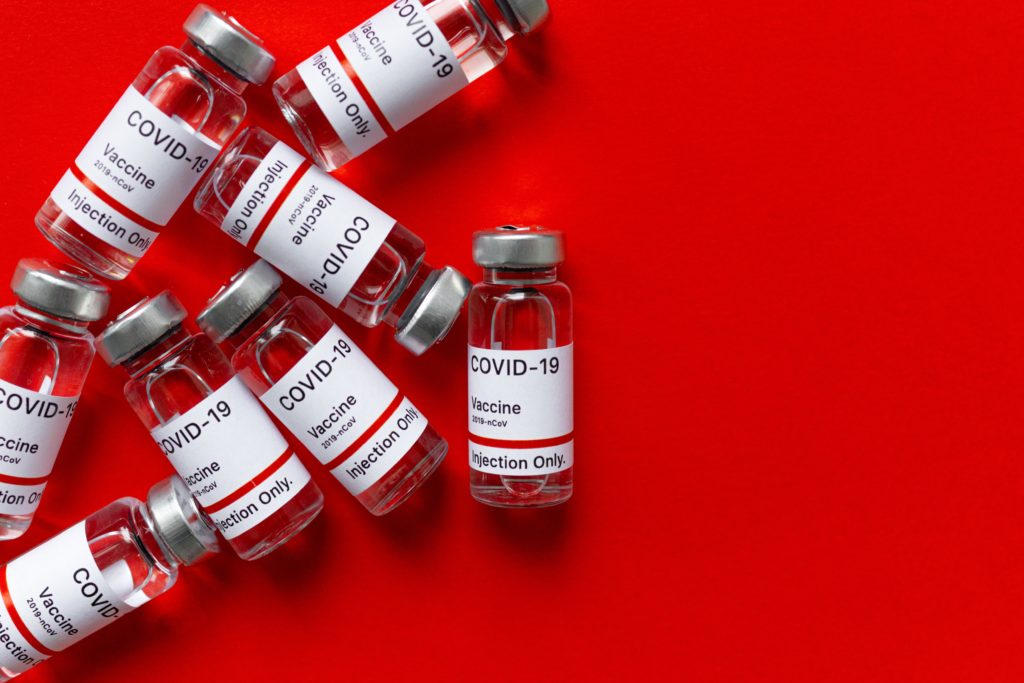 A group of small, clear glass vials labeled
