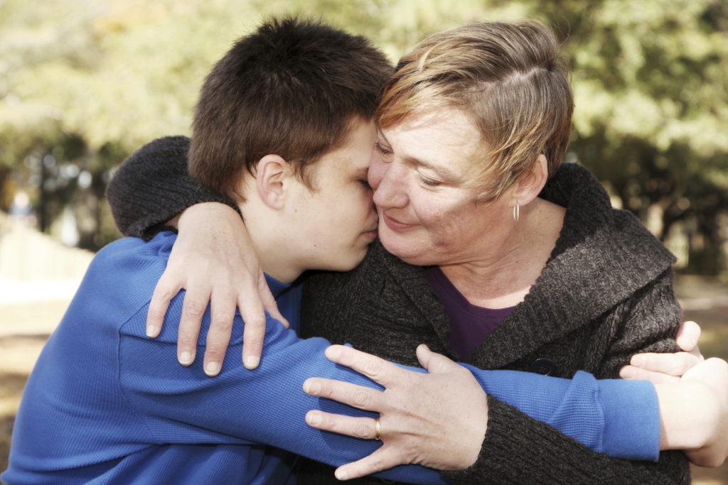 mum hugging teenage boy