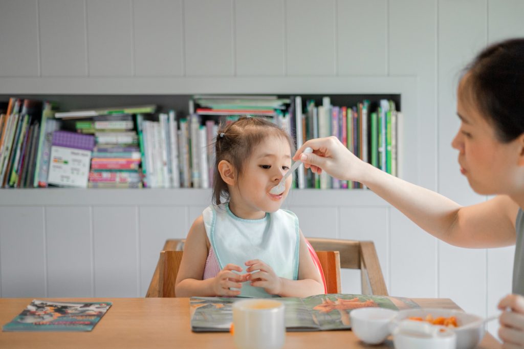 Mum feeding child