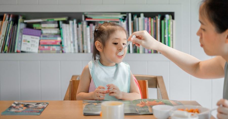 Mum feeding child