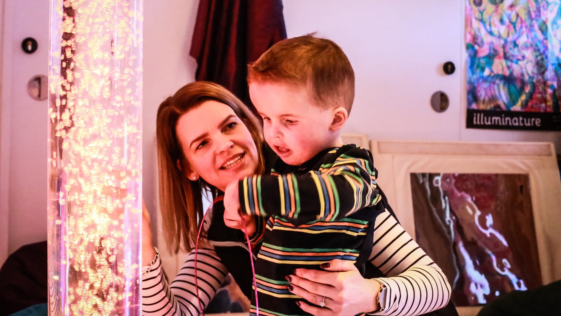 Child and parent looking at lava lamp