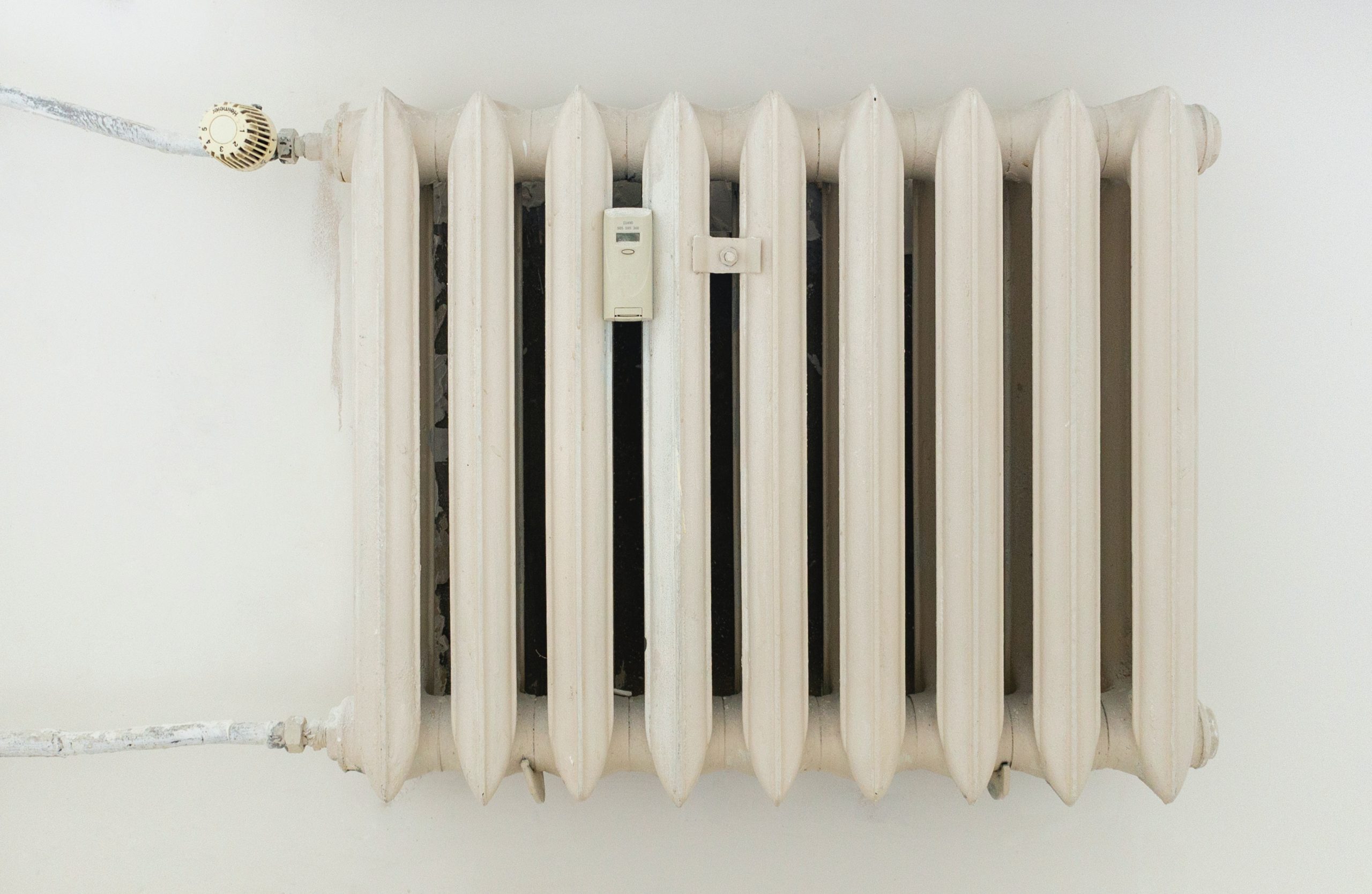 White radiator with heating controls on the front