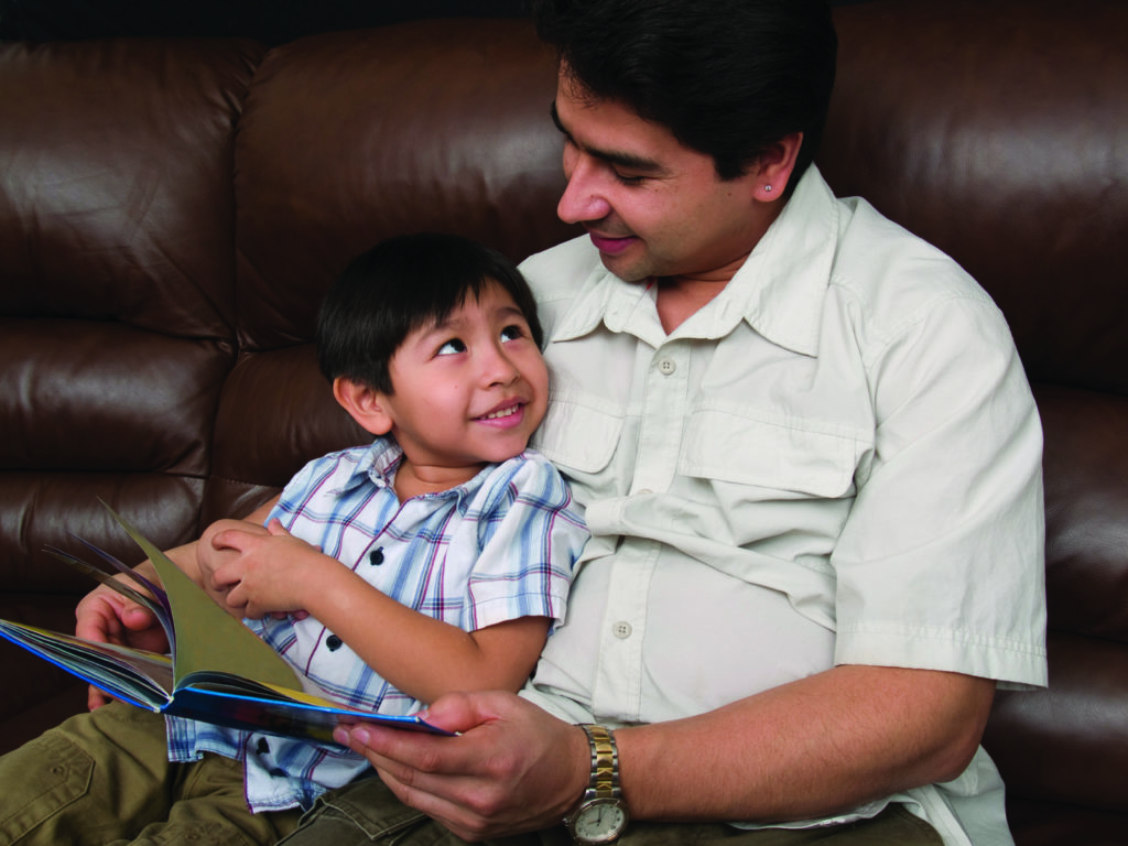 Dad with son reading book