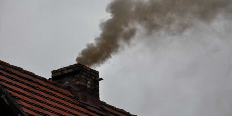 Smoke arising out of a house chimney