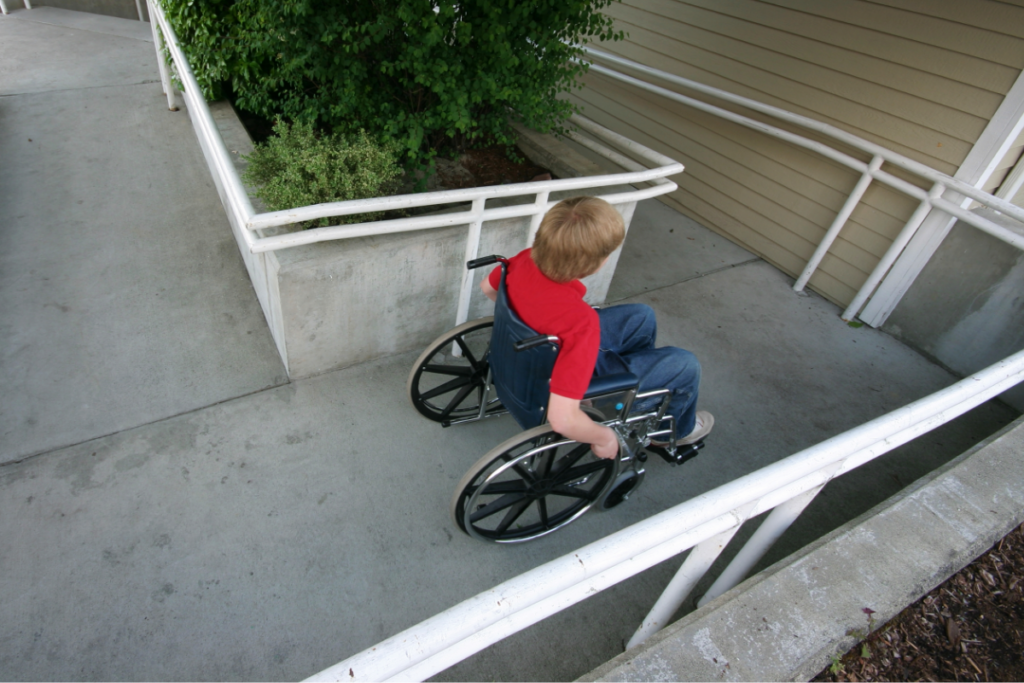 Child in wheelchair moving along ramp
