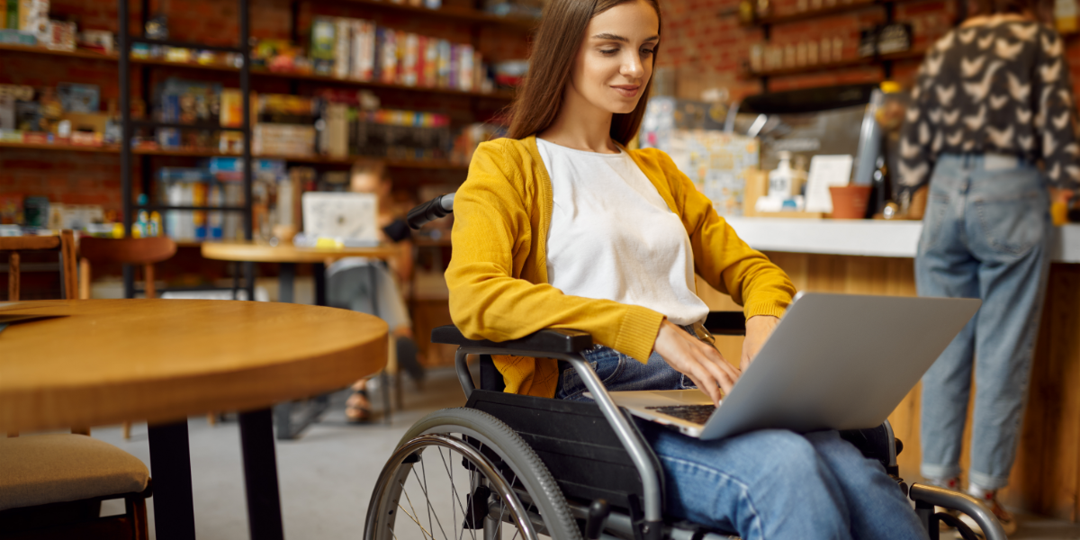 Disabled teenager in wheelchair with laptop