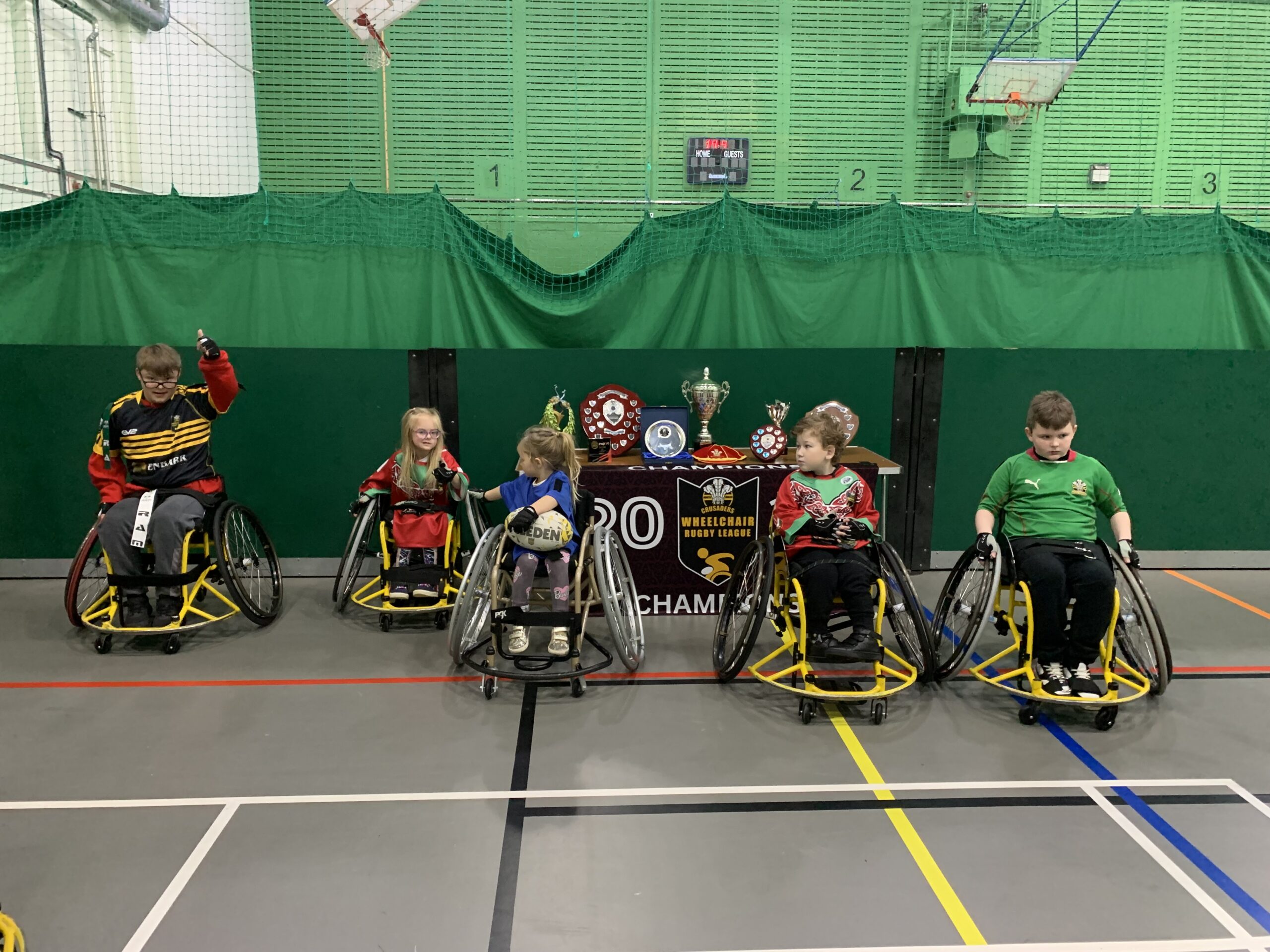 Children in wheelchairs playing sports in a gym