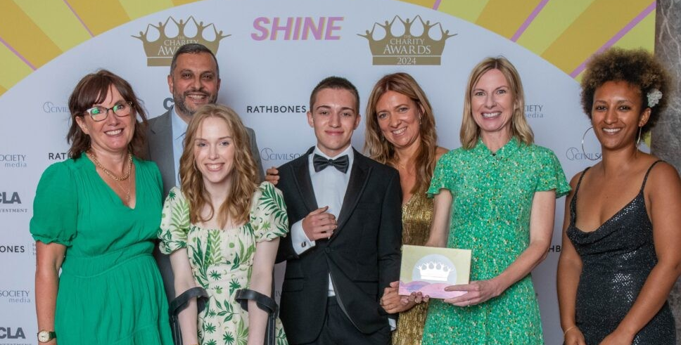 Contact staff with parent campaigner Natalie Hay and son Matteo posing with their award at the Charity Awards 2024