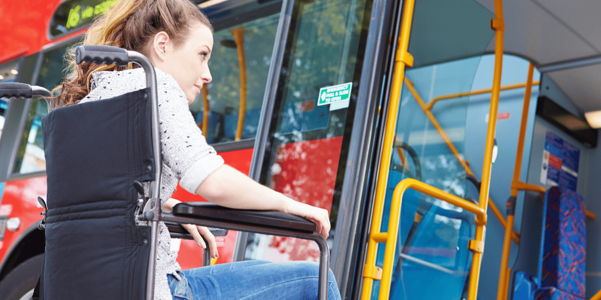 Young woman in a wheelchair getting onto London bus