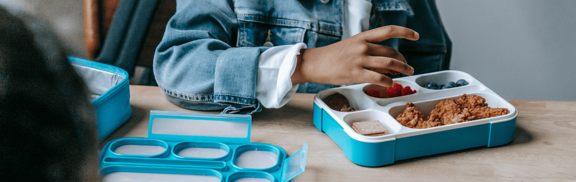 Cropped photo of child eating a packed lunch