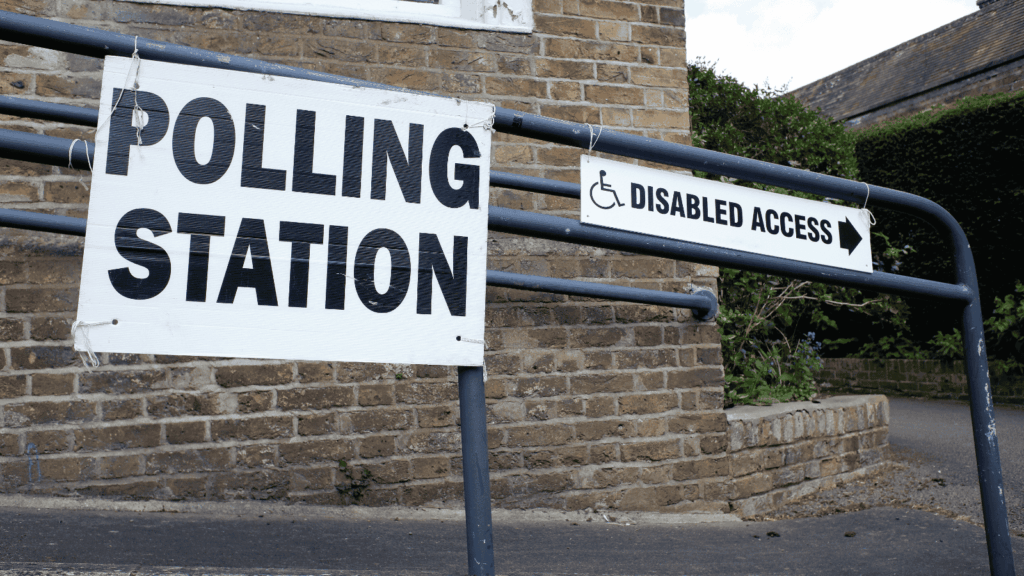 A ramp with a sign saying 'Polling Station' next to a sign saying 'disabled access'