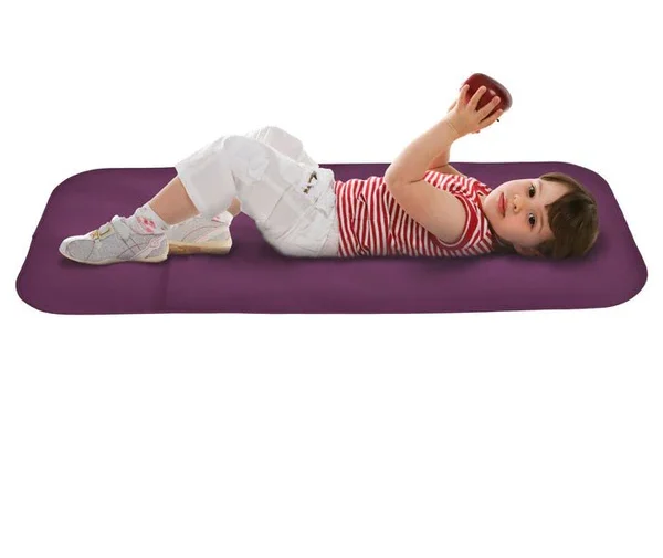 Child lying on a padded changing mat.