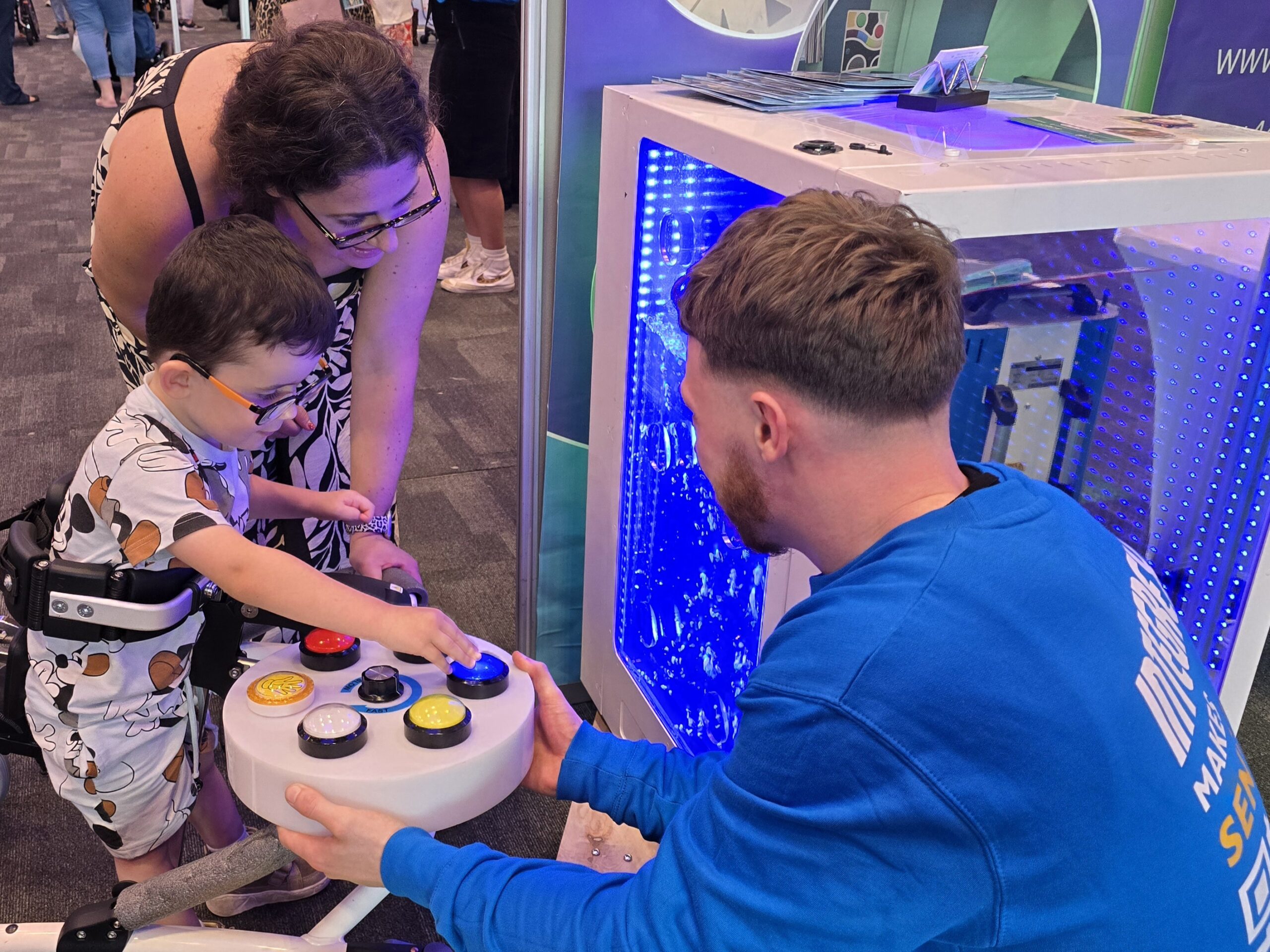 Mum with child who is trying out a sensory toy at a Kidz to Adultz event.