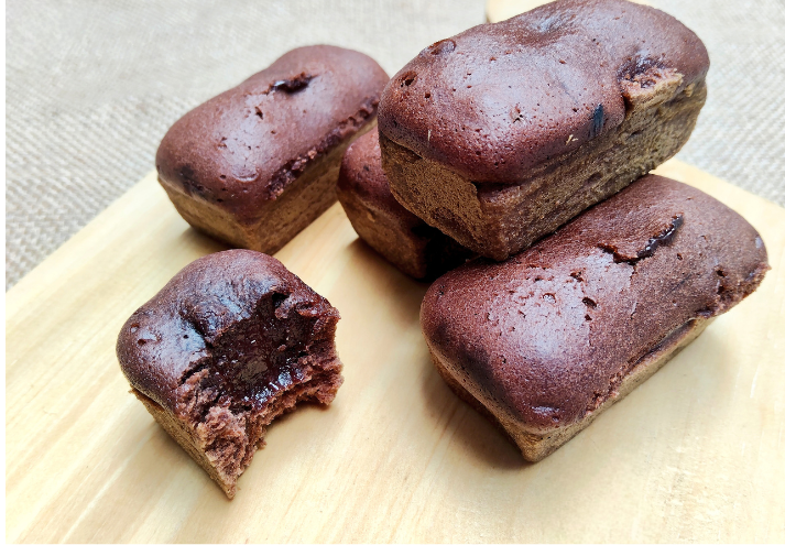 Chocolate cake on a wooden chopping board.