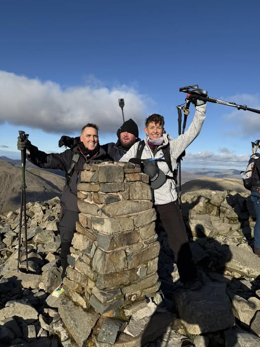 Three men at the top of a mountain taking part in the Three Peaks Challenge for Contact