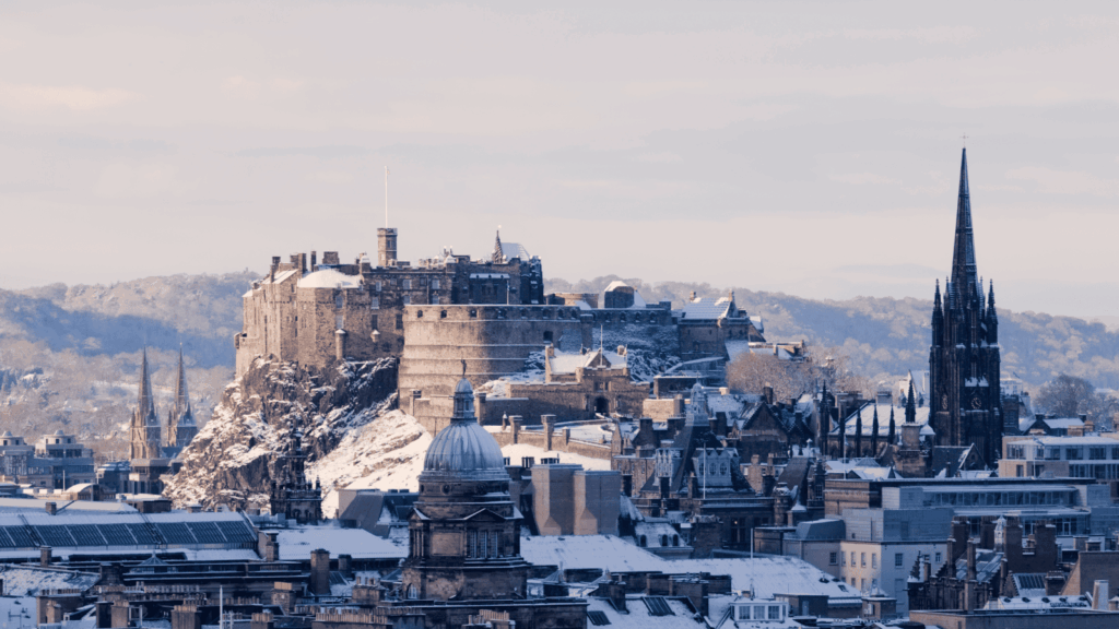 Snowy scene of Edinburgh castle and the surrounding area.
