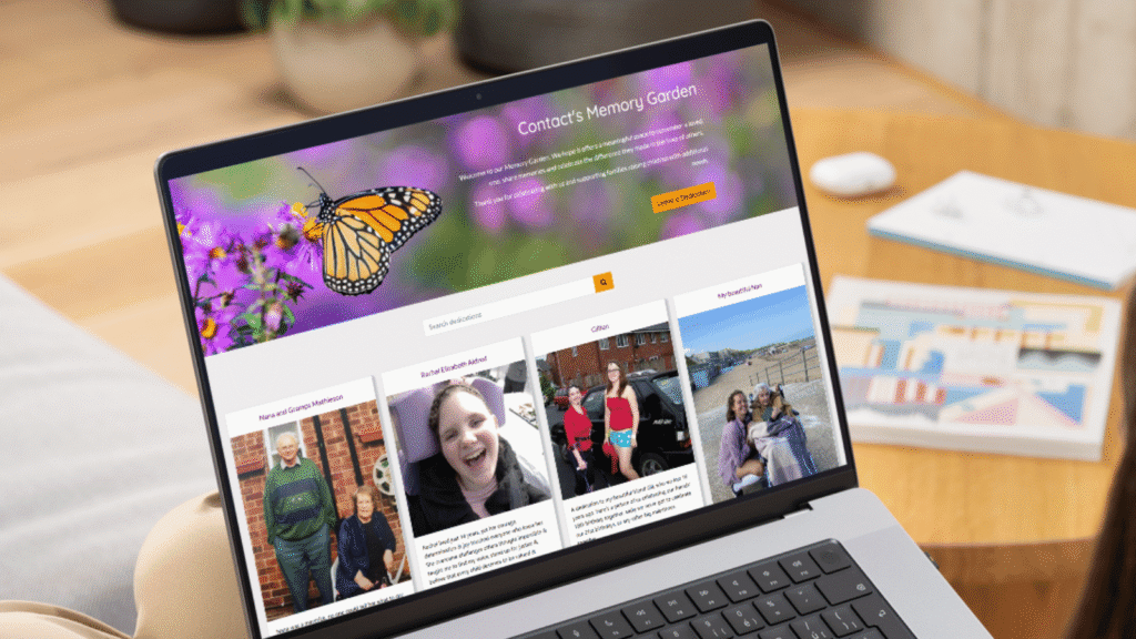 A laptop screen displays a memorial website with a butterfly photo, a search bar, and tribute posts featuring photos and stories of loved ones. A blurred living room is visible in the background.